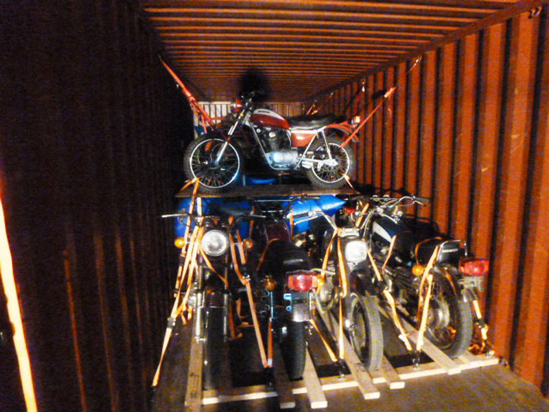 Orange shipping crate filled with motorcycles