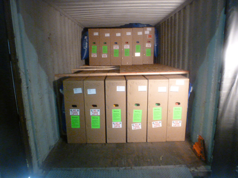 Large white shipping crate filled with large boxes