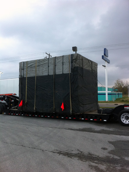 Large oversized box strapped down to truck bed