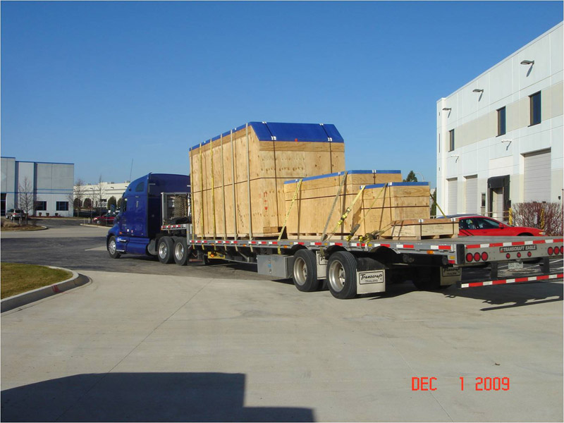Multiple large wooden boxes on the back of a semi-truck